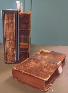 A book in a phase box (our enclosures like to go incognito) and two banded volumes. (Books shown: 1700.2 Crasset v. 1-3)