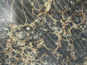 Spanish Marbling. Note the lines running diagonally from the top left of this board to the bottom right; this is what distinguishes Spanish Marbling from Stone. (Book shown: 